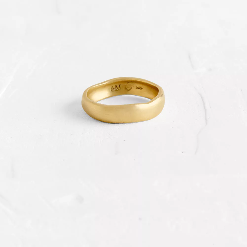 This gold band has a subtle current of curved lines and sits light on the hand. Available also in...