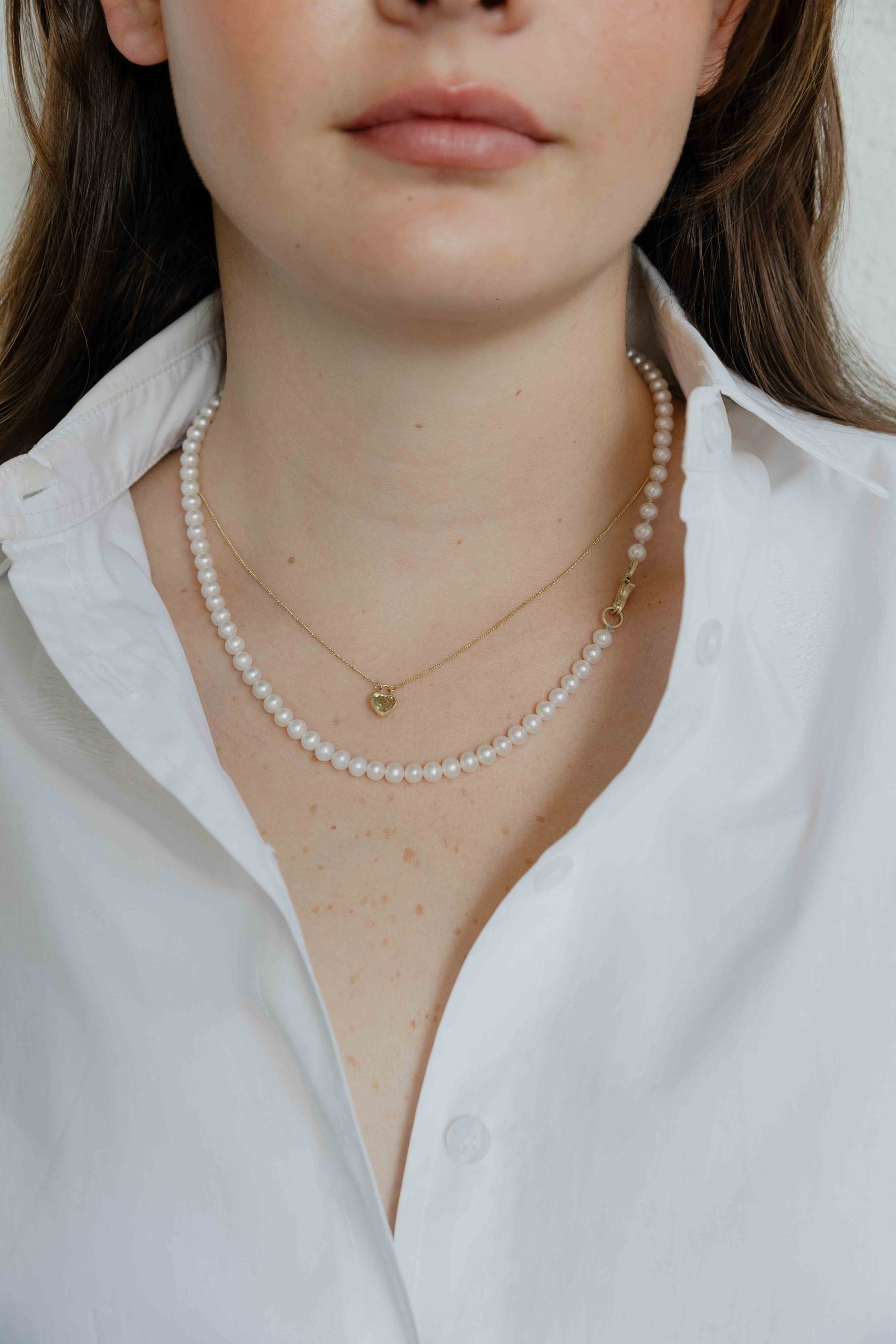 A special white pearls necklace. The classic look gets a twist with an industrial gold locket ,wh... - View 3