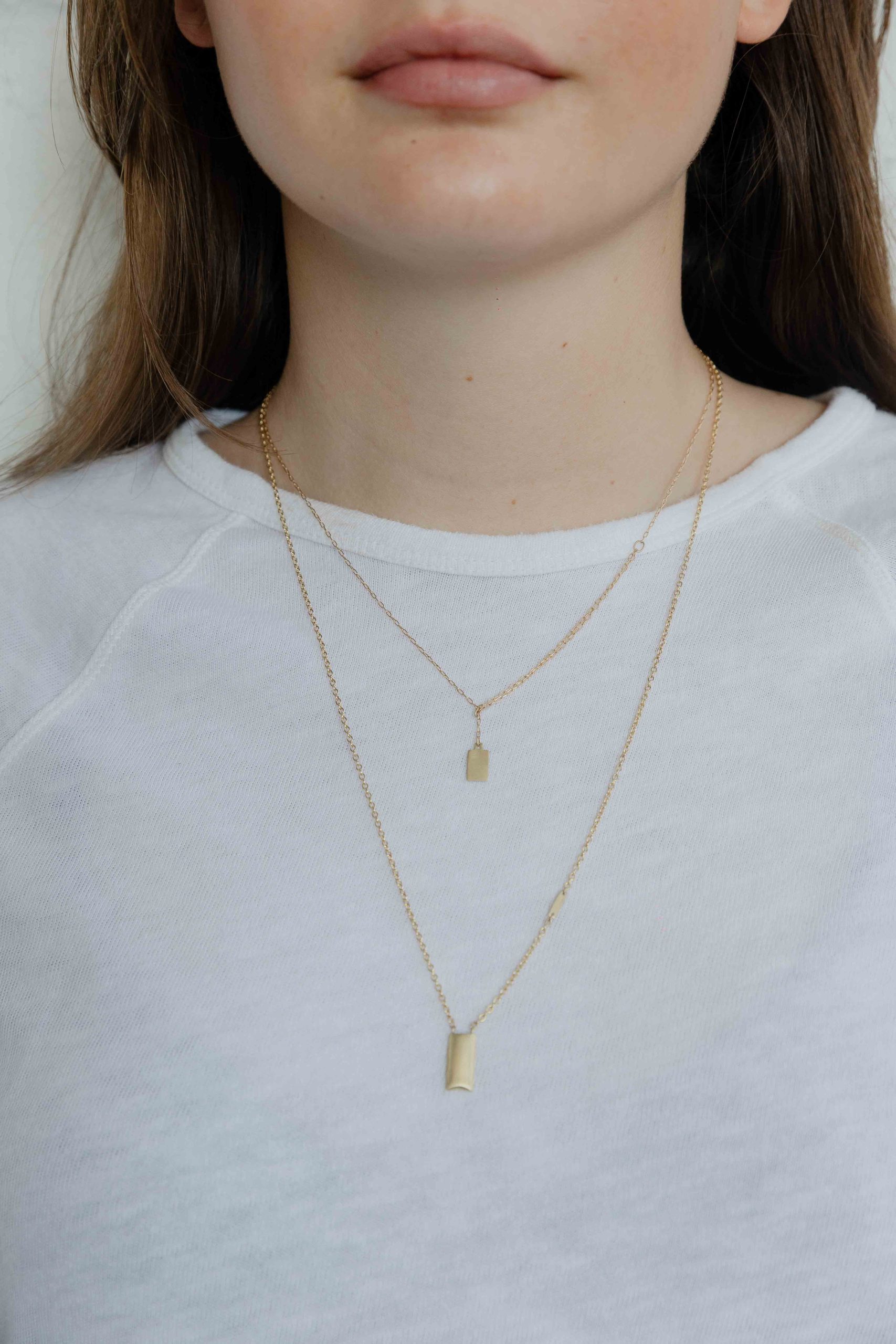 A gold square pendant hangs on a delicate 14K gold necklace. This is a true romantic and dainty p... - View 3