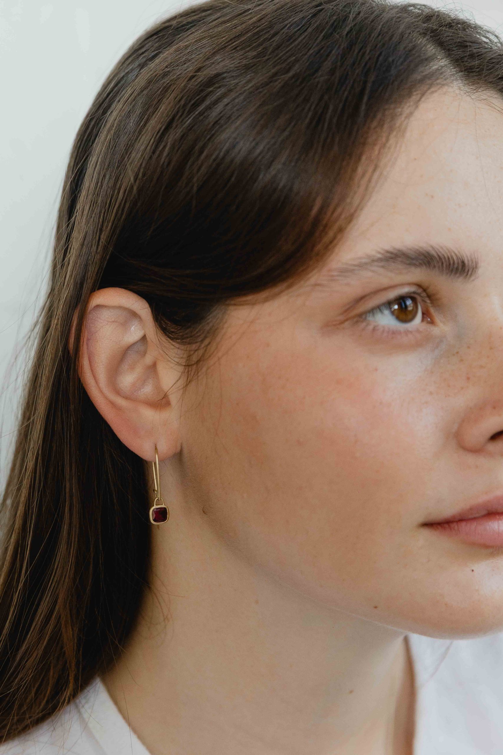 A pair of one of a kind square Ruby stones wrapped in gold hang from hand crafted wire hooks - View 3