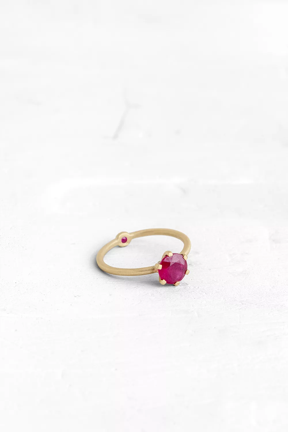 A thin, hoop ring with a setting for a stone or a diamond. The gem shines in its full glory, expo...