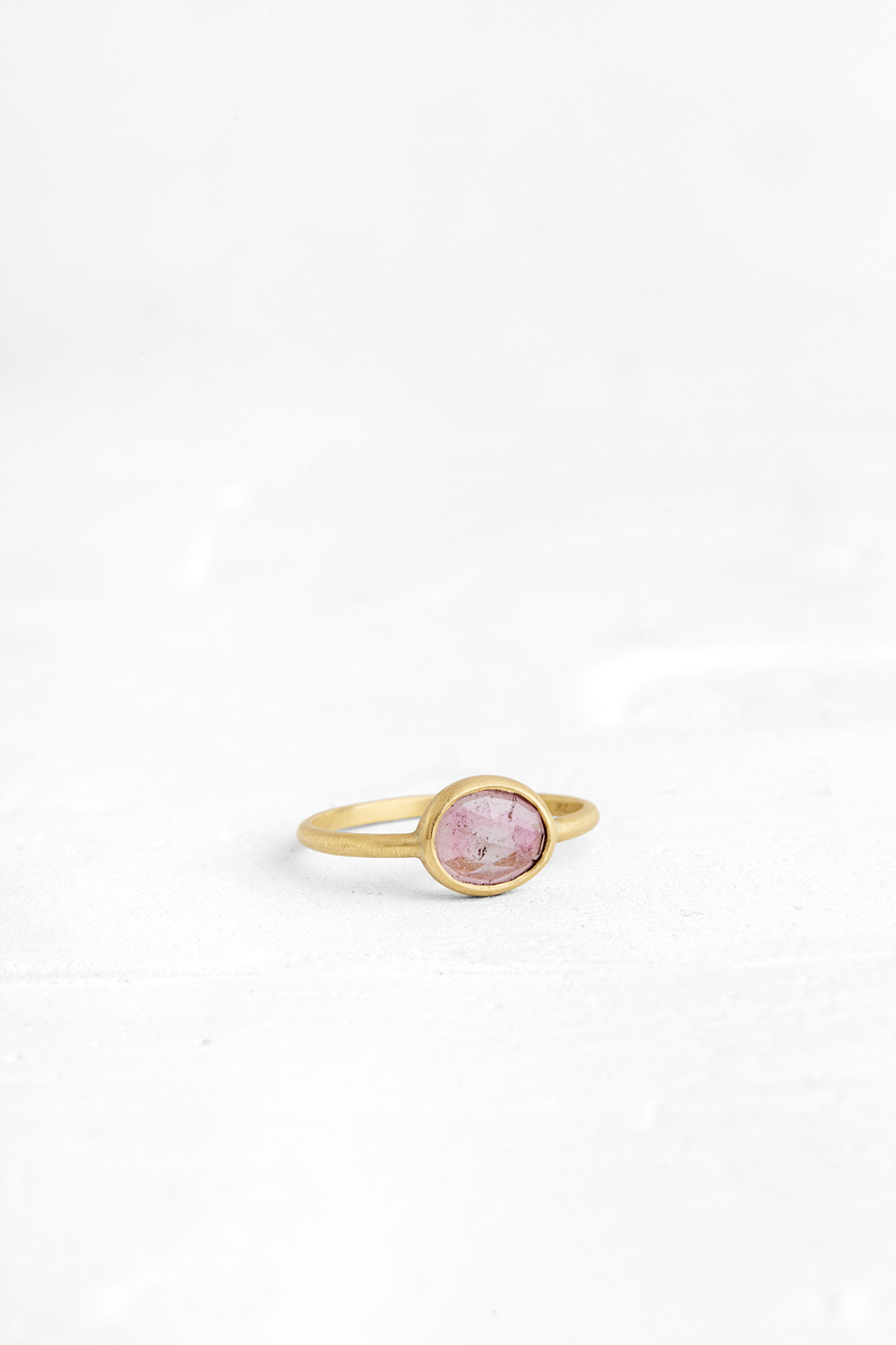 A one-of-a-kind thin ring, set with sliced stones. The setting band cases the selected stone, dif...