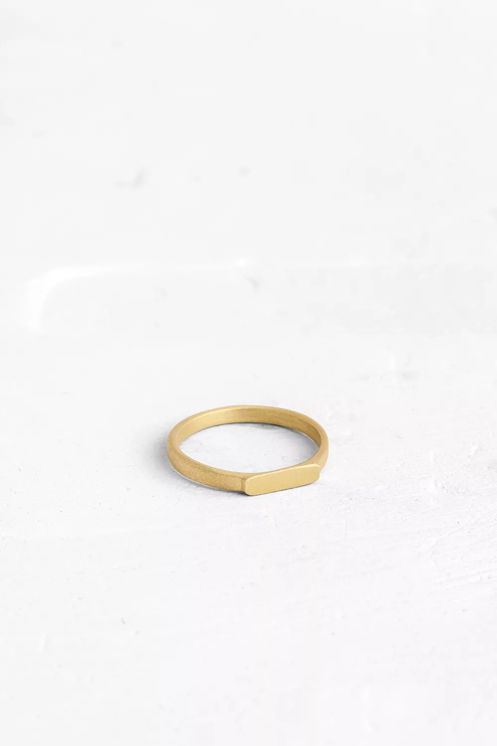 A fine ring that adorns the finger with an elegant, thin, gold band.