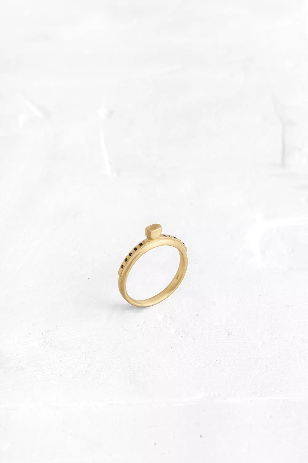 A ring designed from layers of gold - ring on ring. The top layer is speckled with diamonds, like...