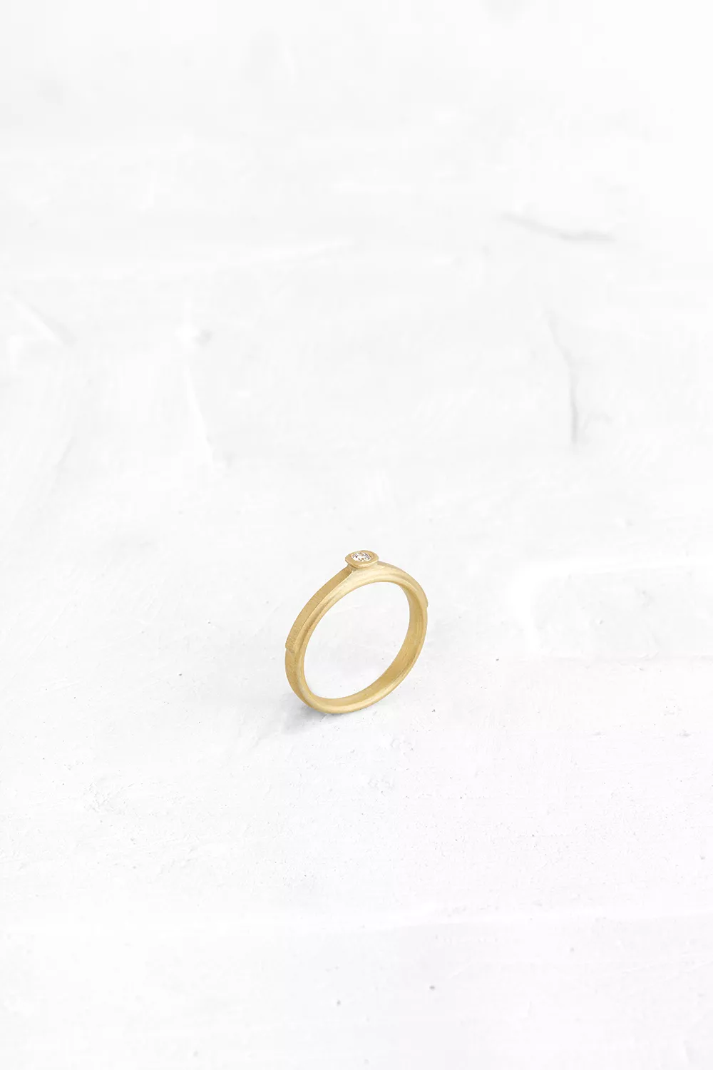 A game of layers of gold; The top of the ring is studded with a diamond that marks the top layer...