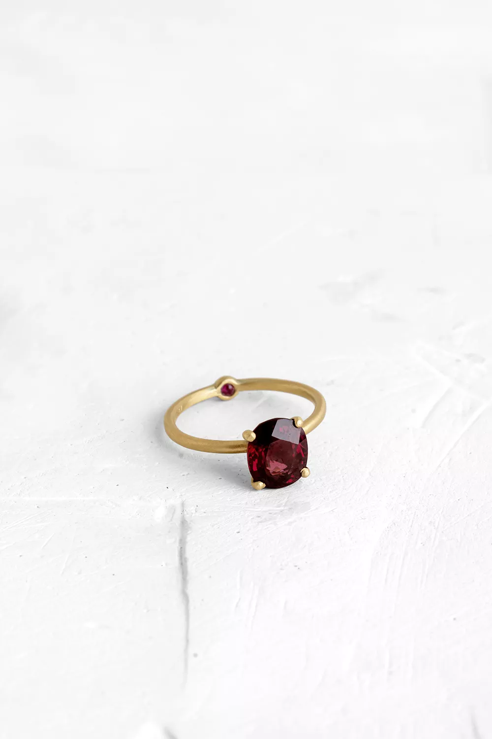 A thin, hoop ring with a setting for a stone or a diamond. The gem shines in its full glory, expo...