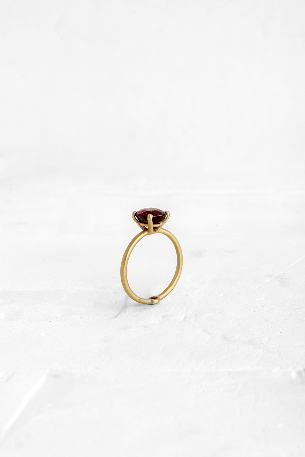 A thin, hoop ring with a setting for a stone or a diamond. The gem shines in its full glory, expo... - View 2