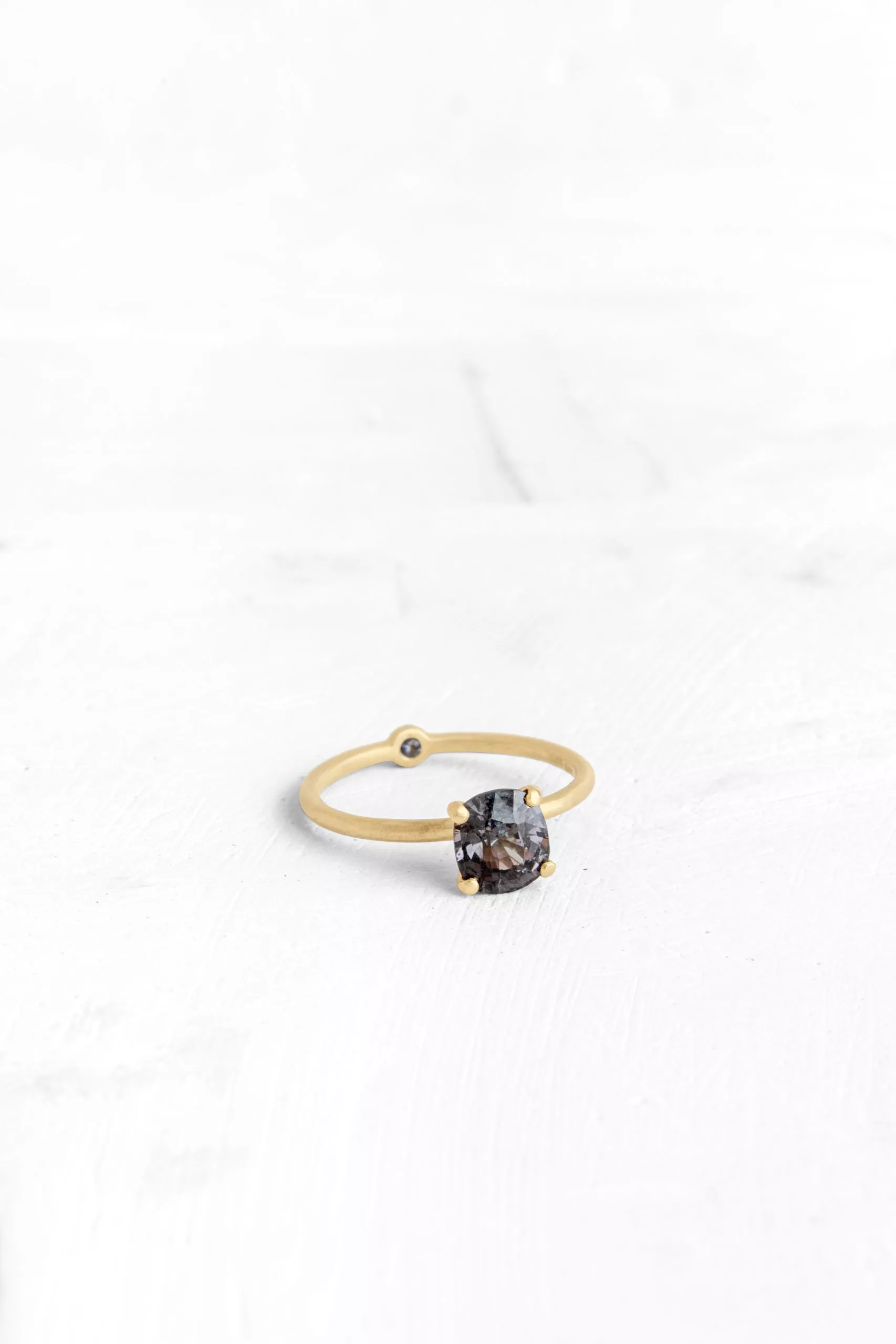 A thin, hoop ring with a setting for a stone or a diamond. The gem shines in its full glory, expo...