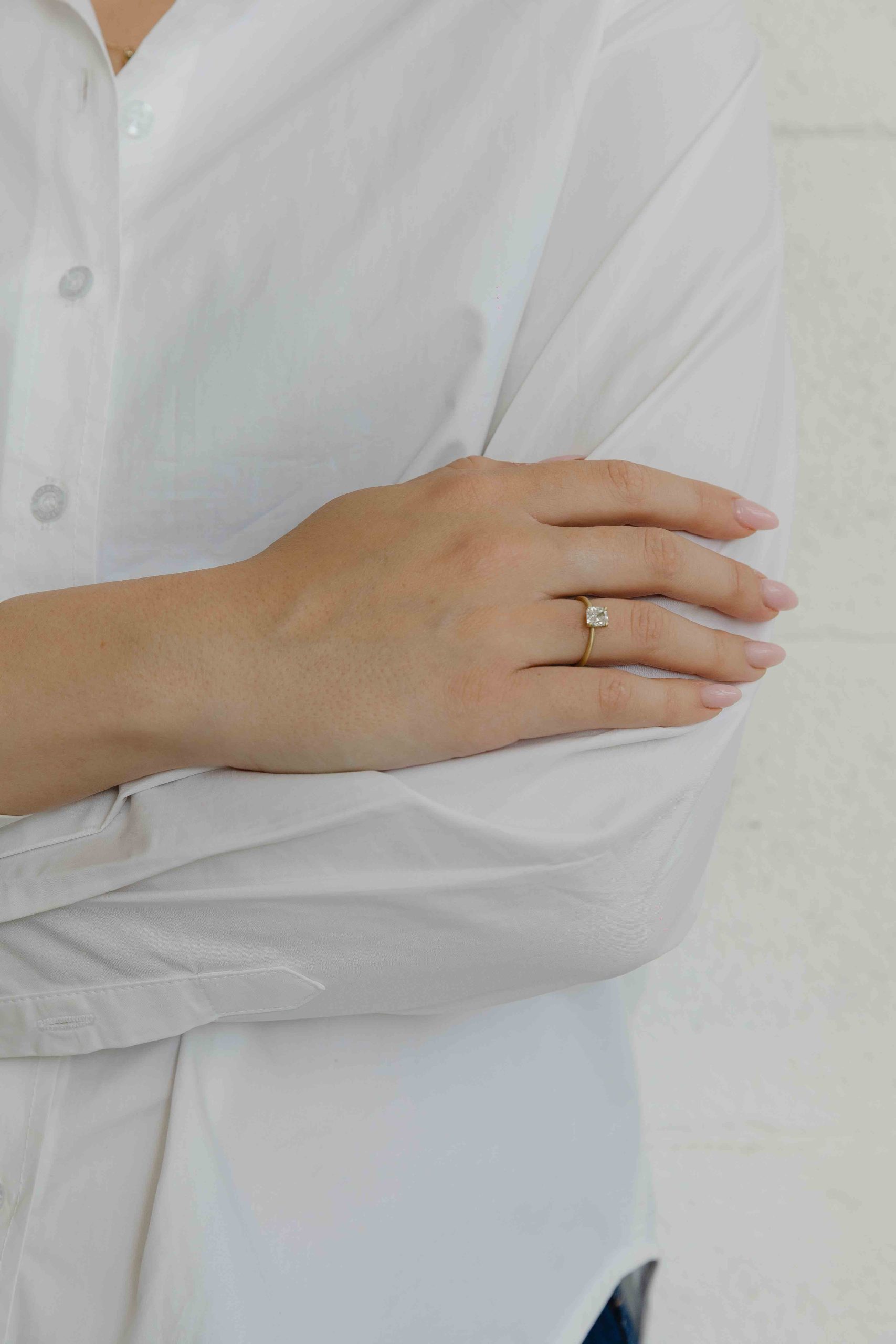 A thin, hoop ring with a setting for a stone or a diamond. The gem shines in its full glory, expo... - View 3