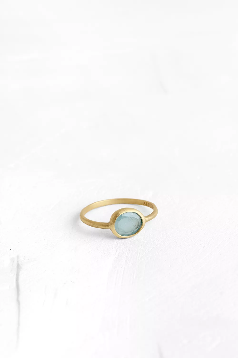 A one-of-a-kind thin ring, set with sliced stones. The setting band cases the selected stone, dif...