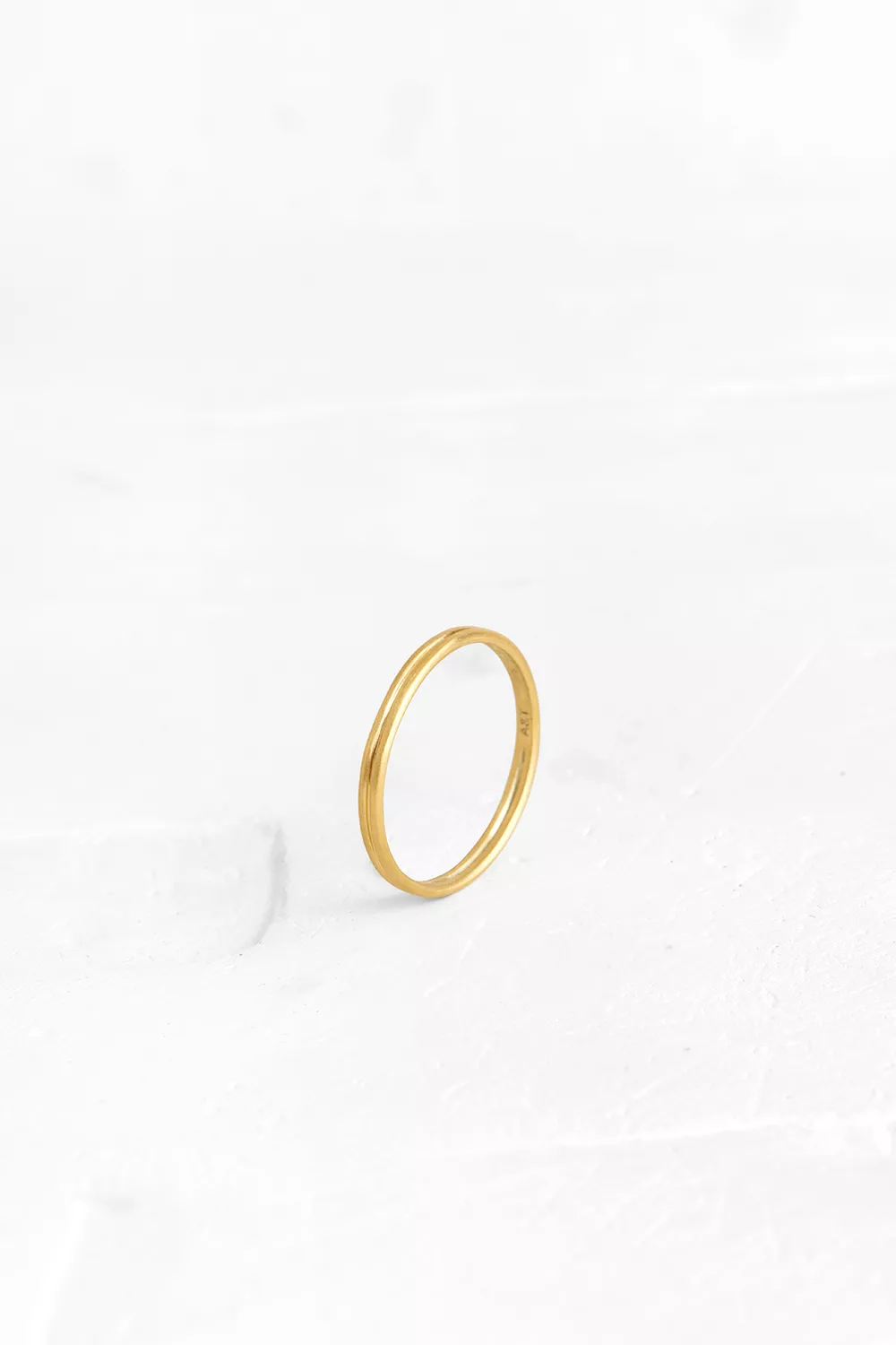 This minimalistic ring is crafted as a thin round band with a delicate groove. It is perfect as a...