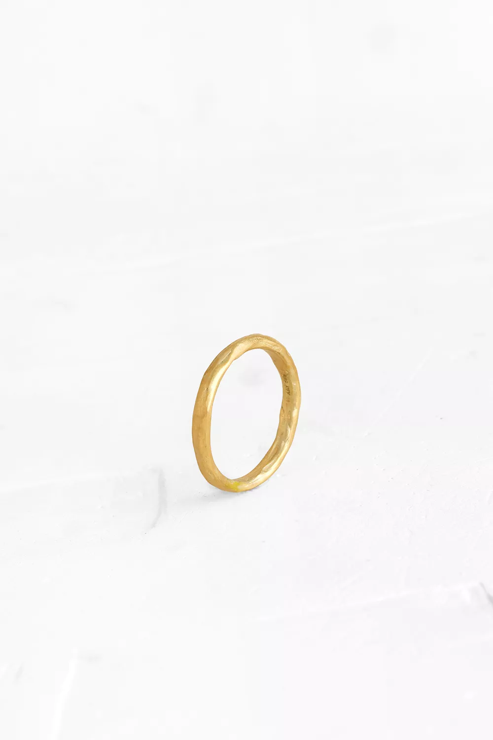 This gold band has a subtle current of curved lines and sits light on the hand. Available also in...