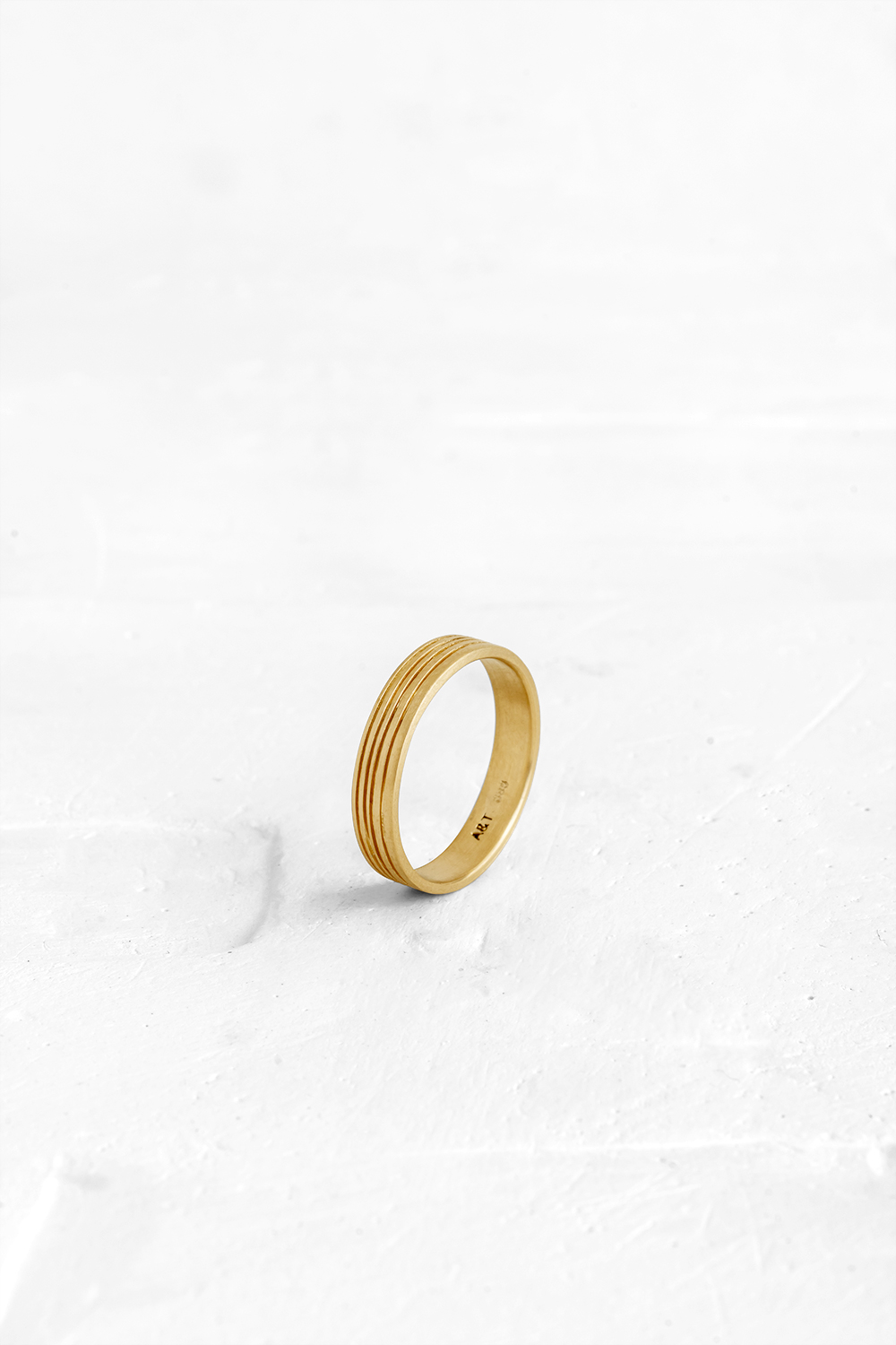 A gold ring featuring several gentle slits in the metal. Although delicate, the ring has a strong... - View 2