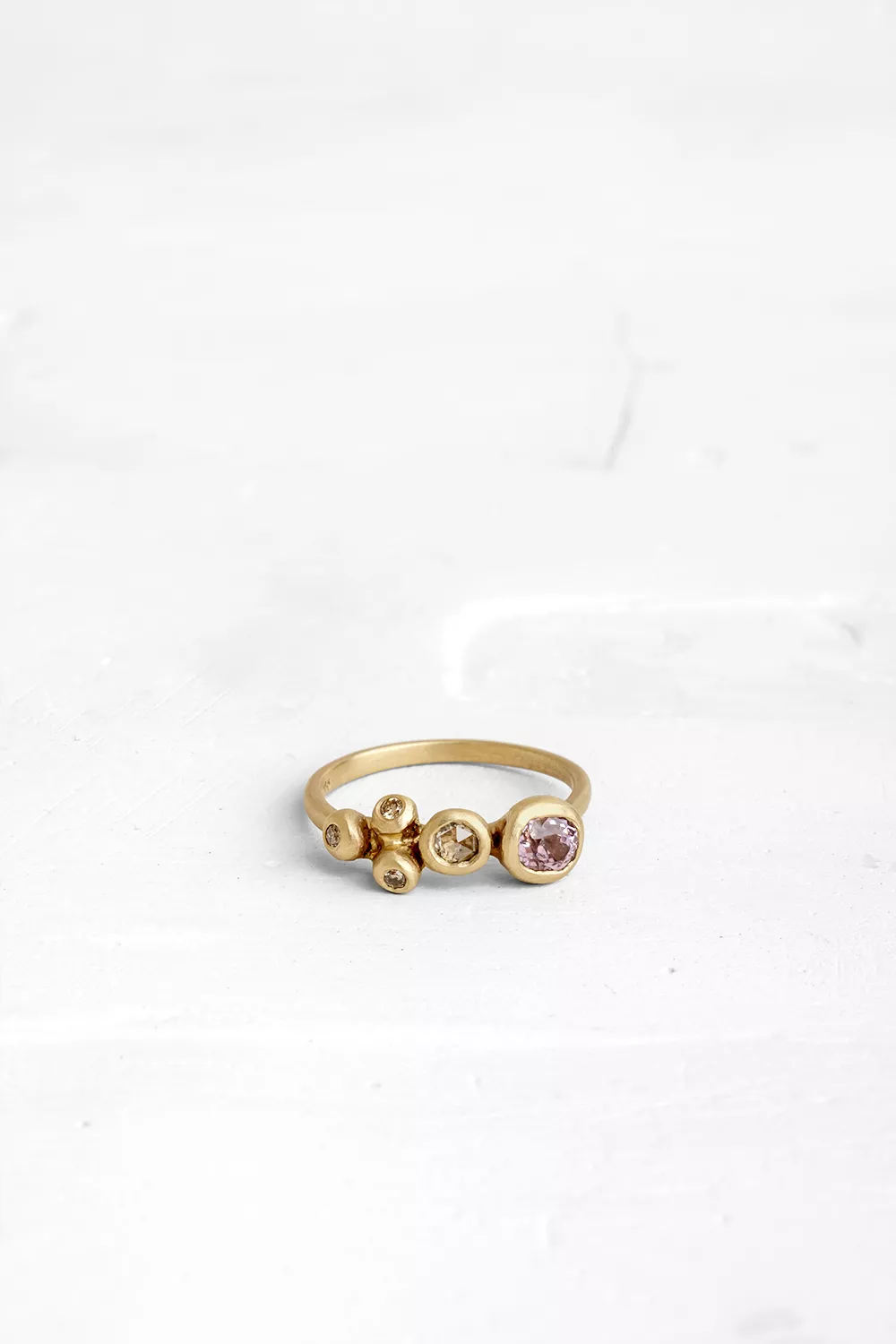 A collection of diamonds and gemstones, Set in an Asymmetrically way, Creating the appearance o...