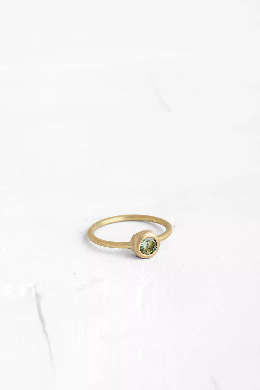 A timeless piece: this gold ring features a handmade bezel set with a round Green Tourmaline
