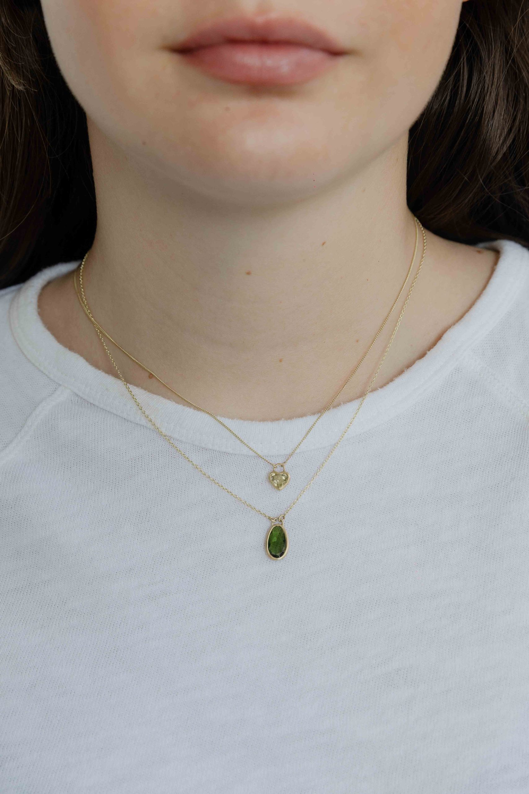 A handmade pendant is set with a Green Tourmaline stone which hangs on a delicate chain. - View 3