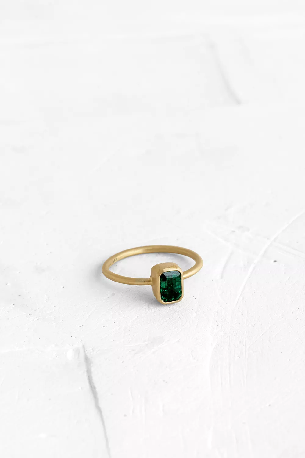 A timeless piece: this gold ring features a handmade bezel set with an Emerald.