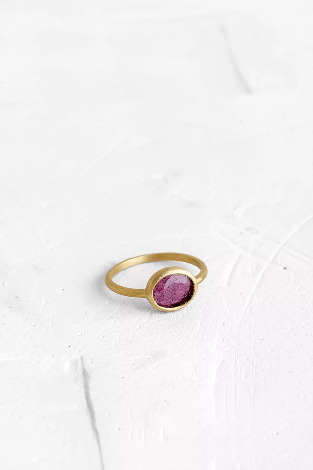 A one-of-a-kind thin ring, set with sliced stones. The setting band cases the selected stone, dif...