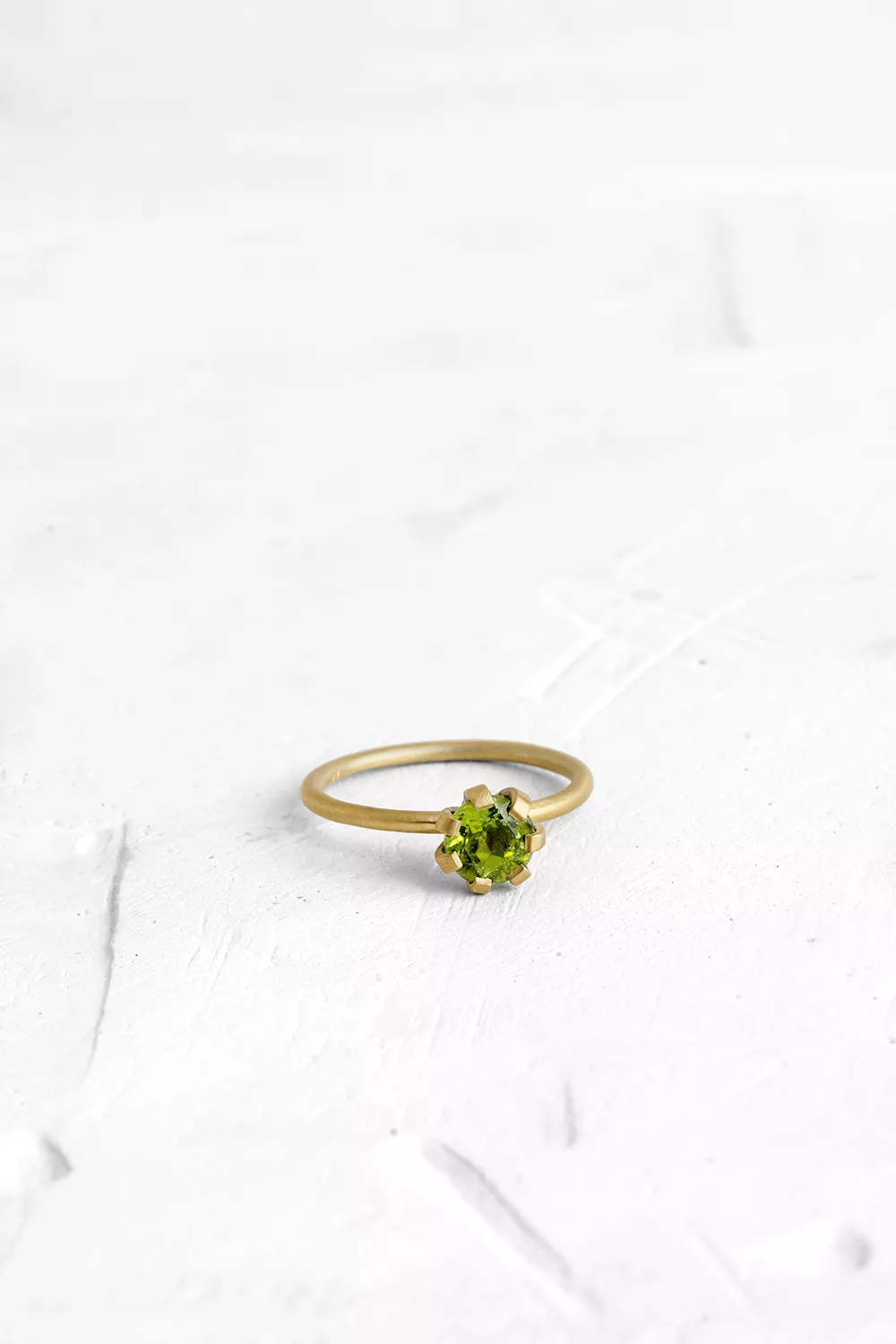 A thin, hoop ring with a setting for a stone or a diamond. The gem shines in its full glory, expo...