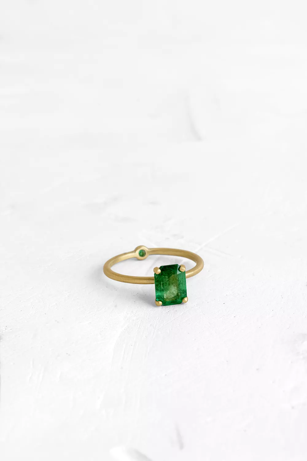A thin, hoop ring with a setting for a stone or a diamond. The gem shines in its full glory, expo...