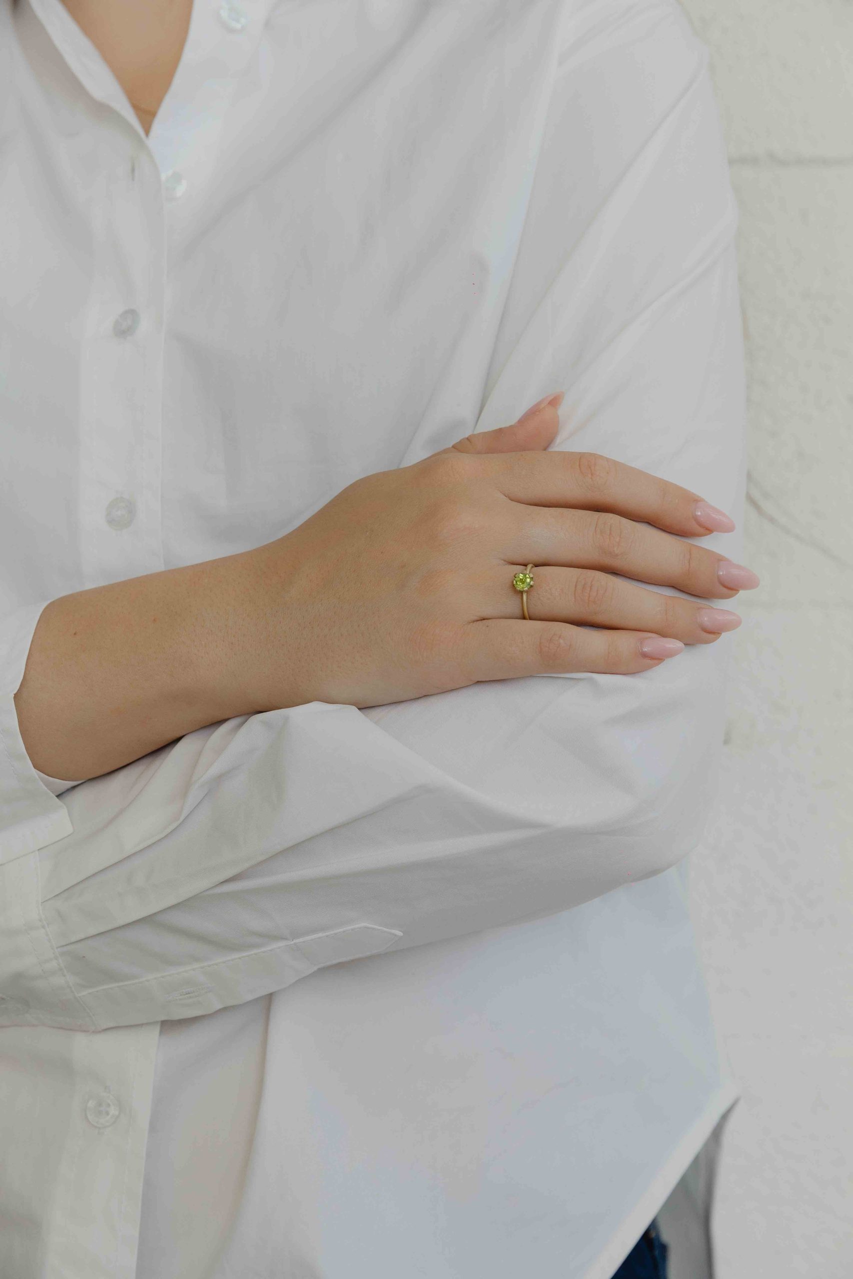 A thin, hoop ring with a setting for a stone or a diamond. The gem shines in its full glory, expo... - View 4