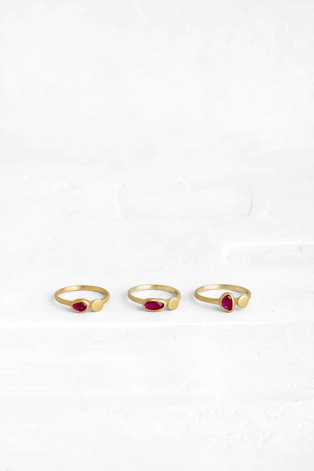 A gentle gold ring set with a slice of Ruby and a gold element coexisting side by side.Each rin... - View 3