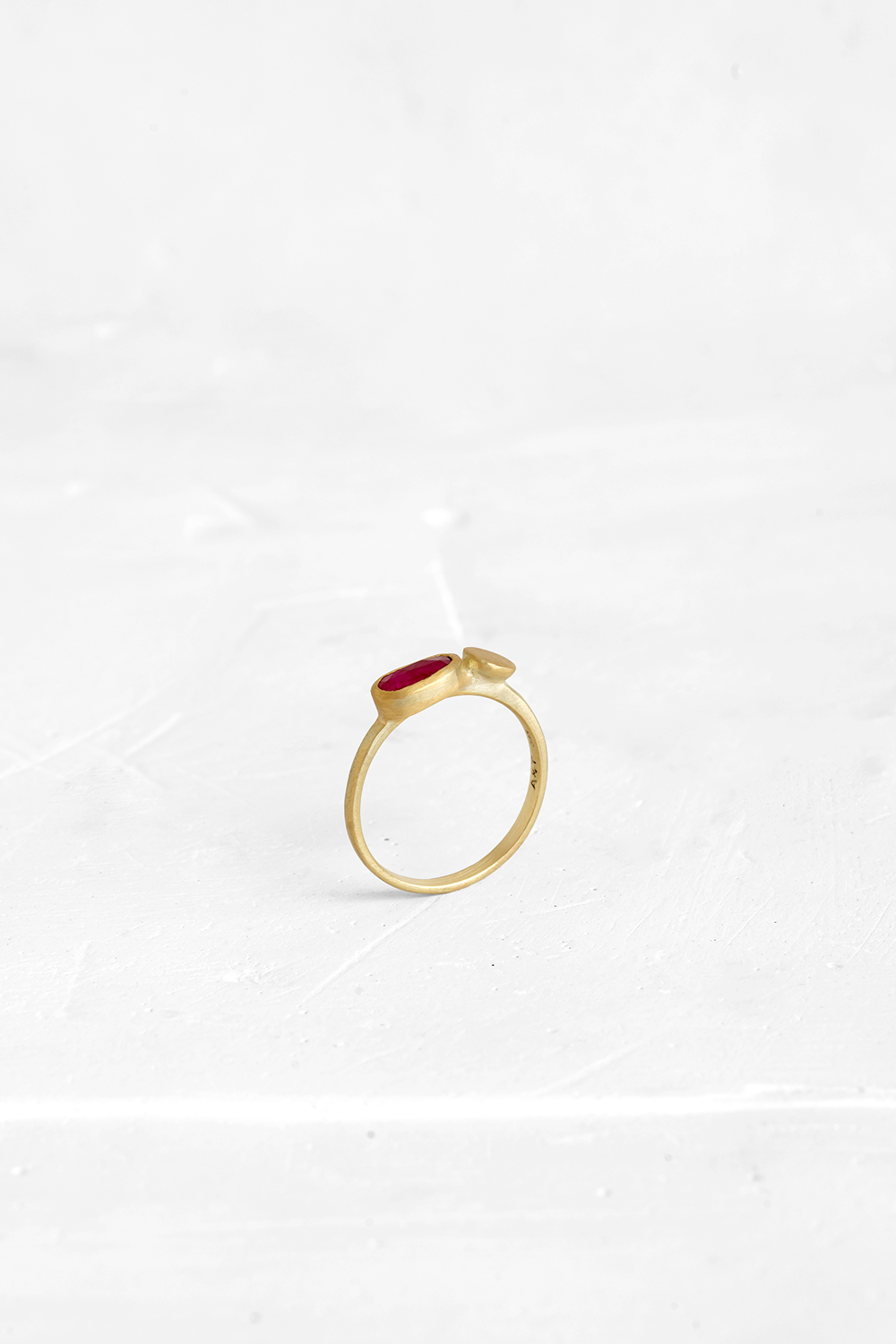 A gentle gold ring set with a slice of Ruby and a gold element coexisting side by side.Each rin... - View 2
