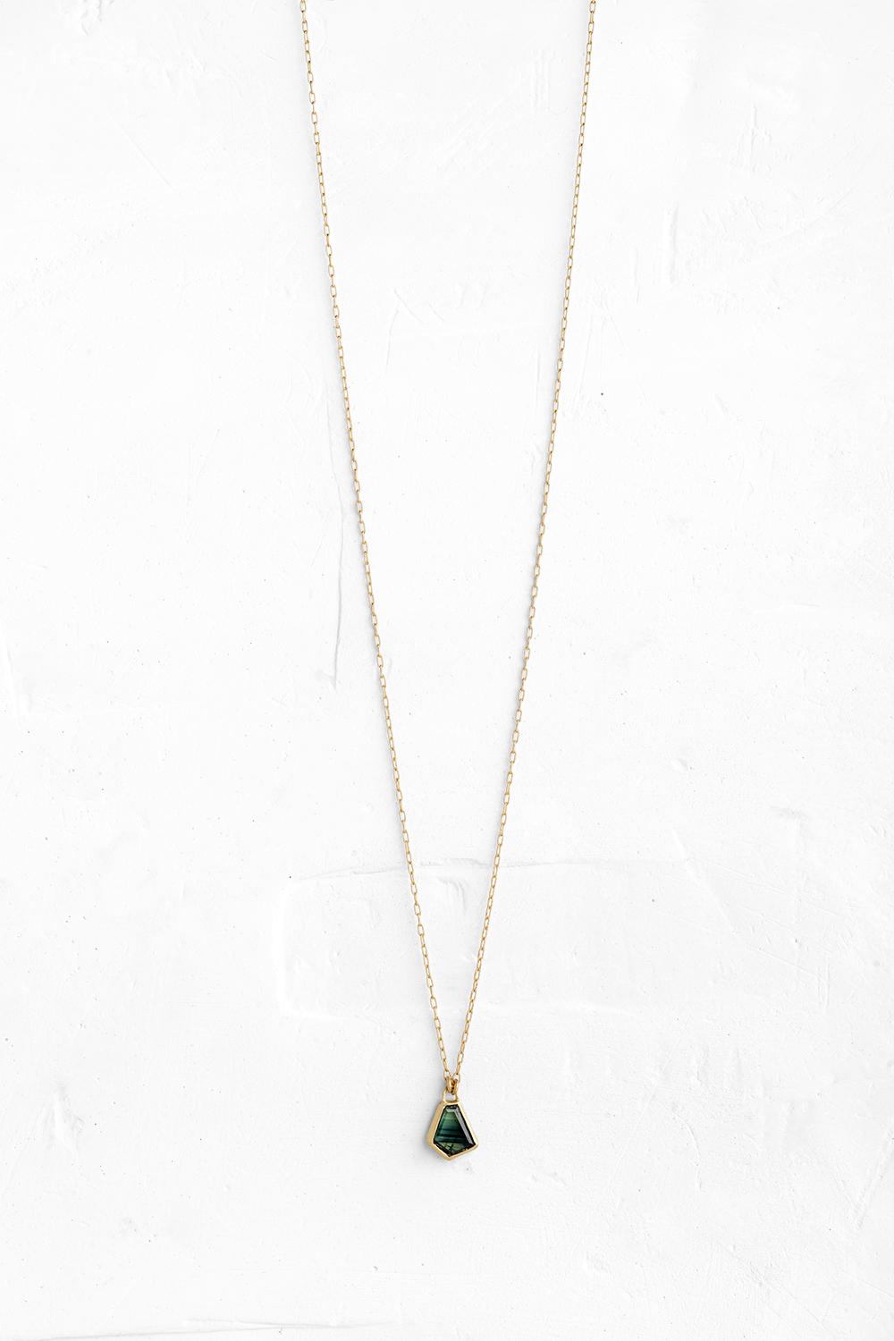 A handmade pendant set with a beautiful amorphous shaped Green Sapphire hanging on a delicate gol... - View 2