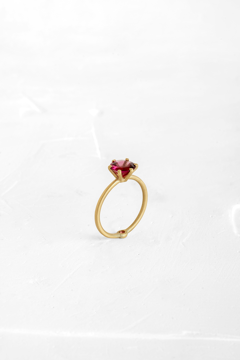 A thin, hoop ring with a setting for a stone or a diamond. The gem shines in its full glory, expo... - View 2