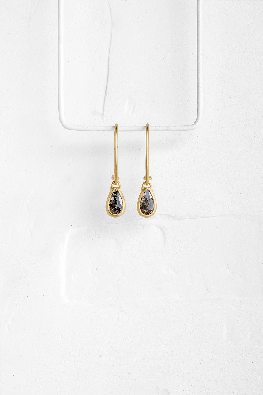 A pair of a drop shaped Diamante stones wrapped in gold hang from hand crafted wire hooks

&nbsp;