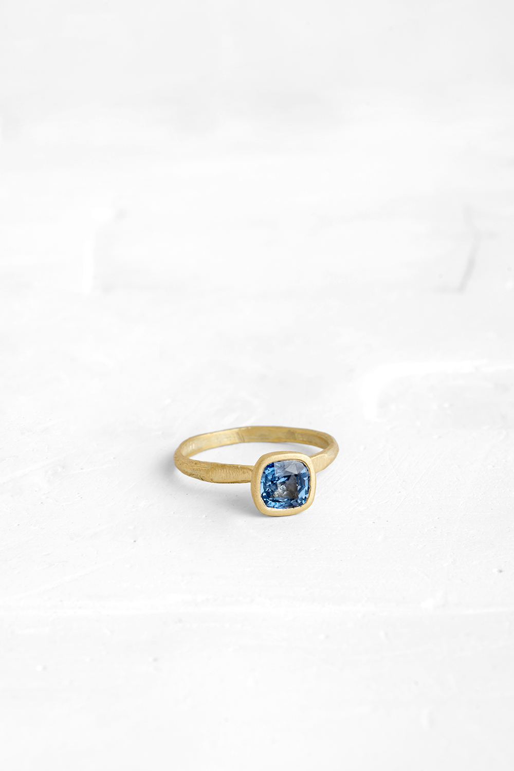 This Blue Saphire is the beating-heart of this delicate ring. The raw nature of the gold band mak...