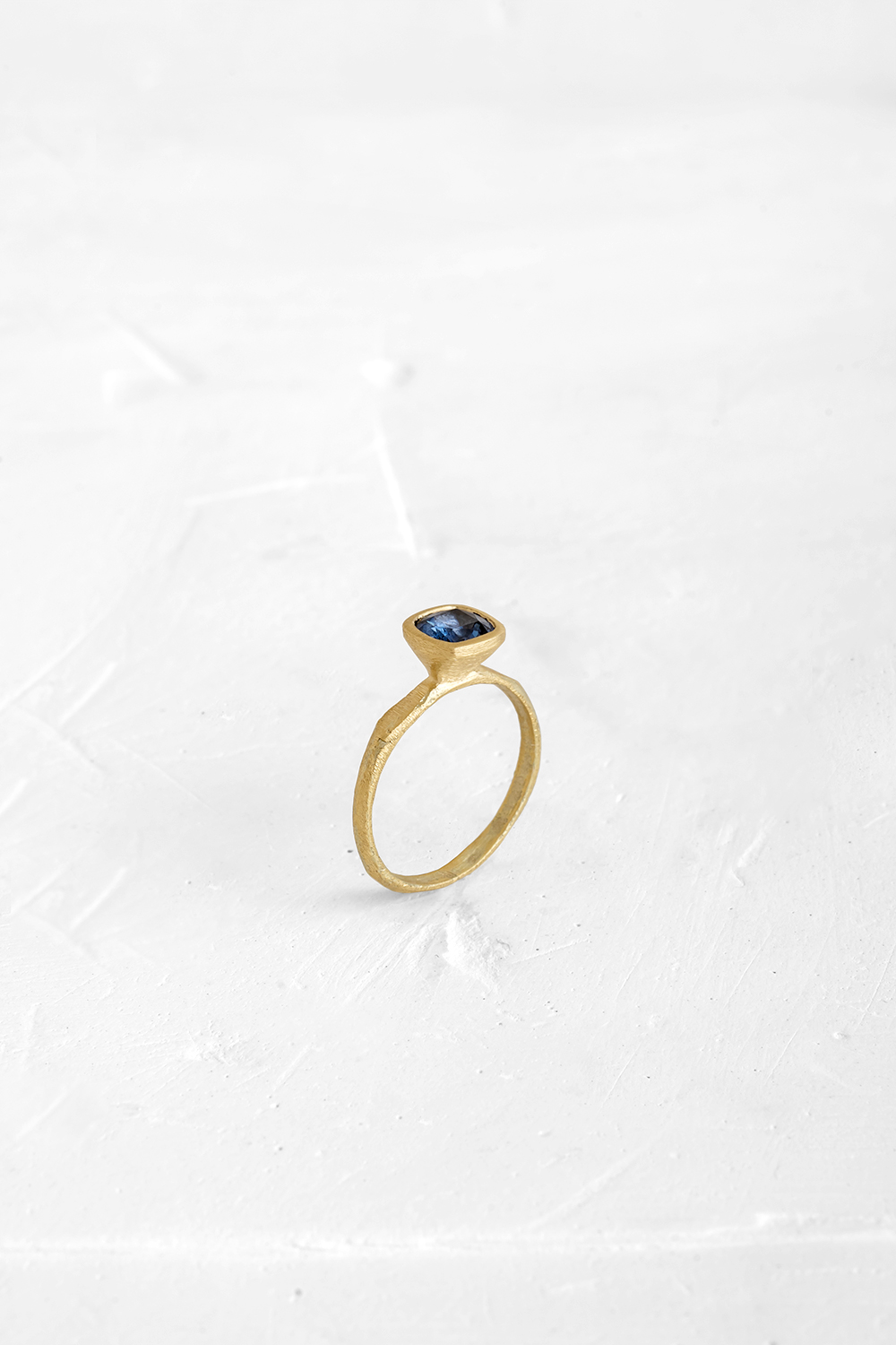 This Blue Saphire is the beating-heart of this delicate ring. The raw nature of the gold band mak... - View 2