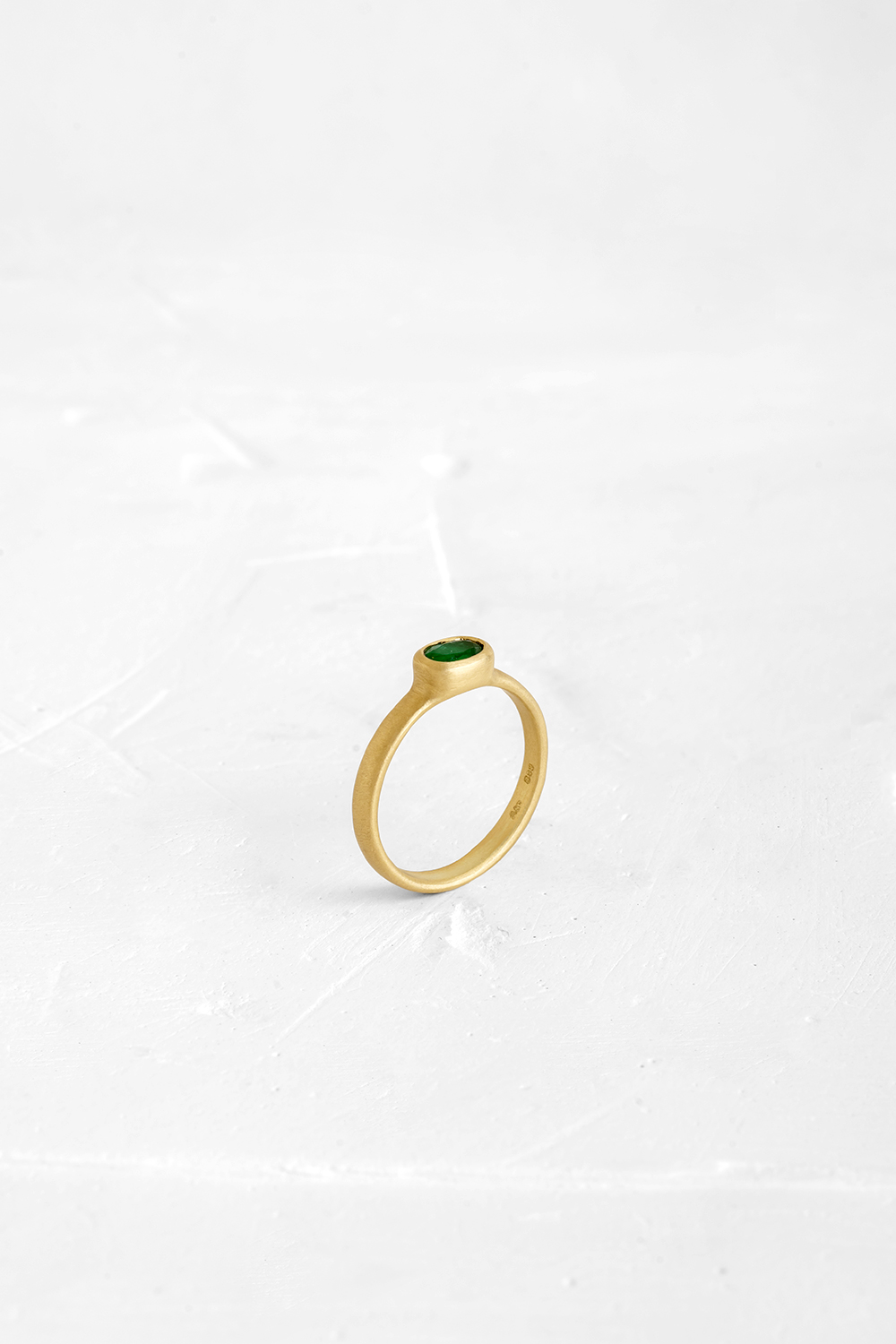 The band and the bezel are both crafted into one fluid piece in this ring and set with an Emerald - View 2