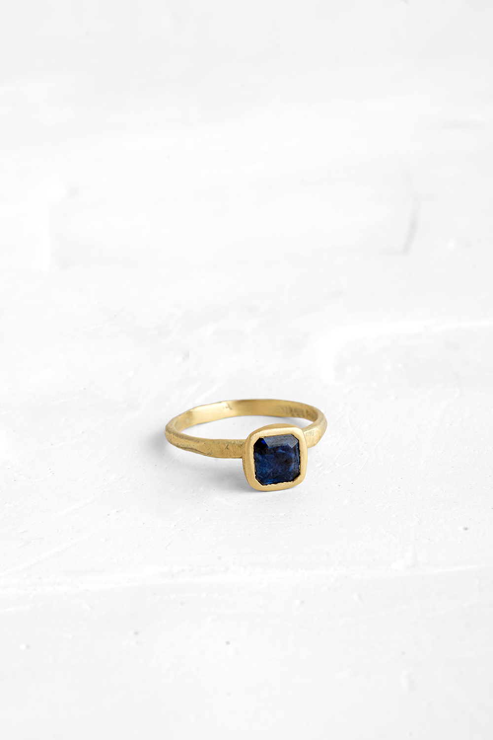 This Blue Saphire is the beating-heart of this delicate ring. The raw nature of the gold band mak...