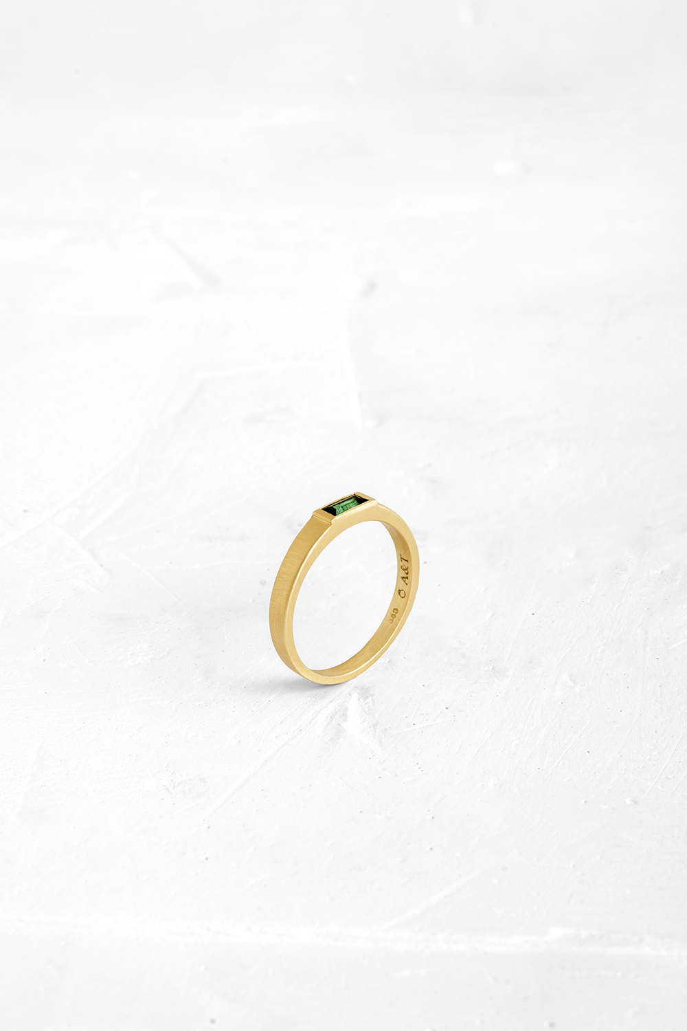 This sleek ring has a flattened bezel that is almost flush with the band and is set with a Green ... - View 2