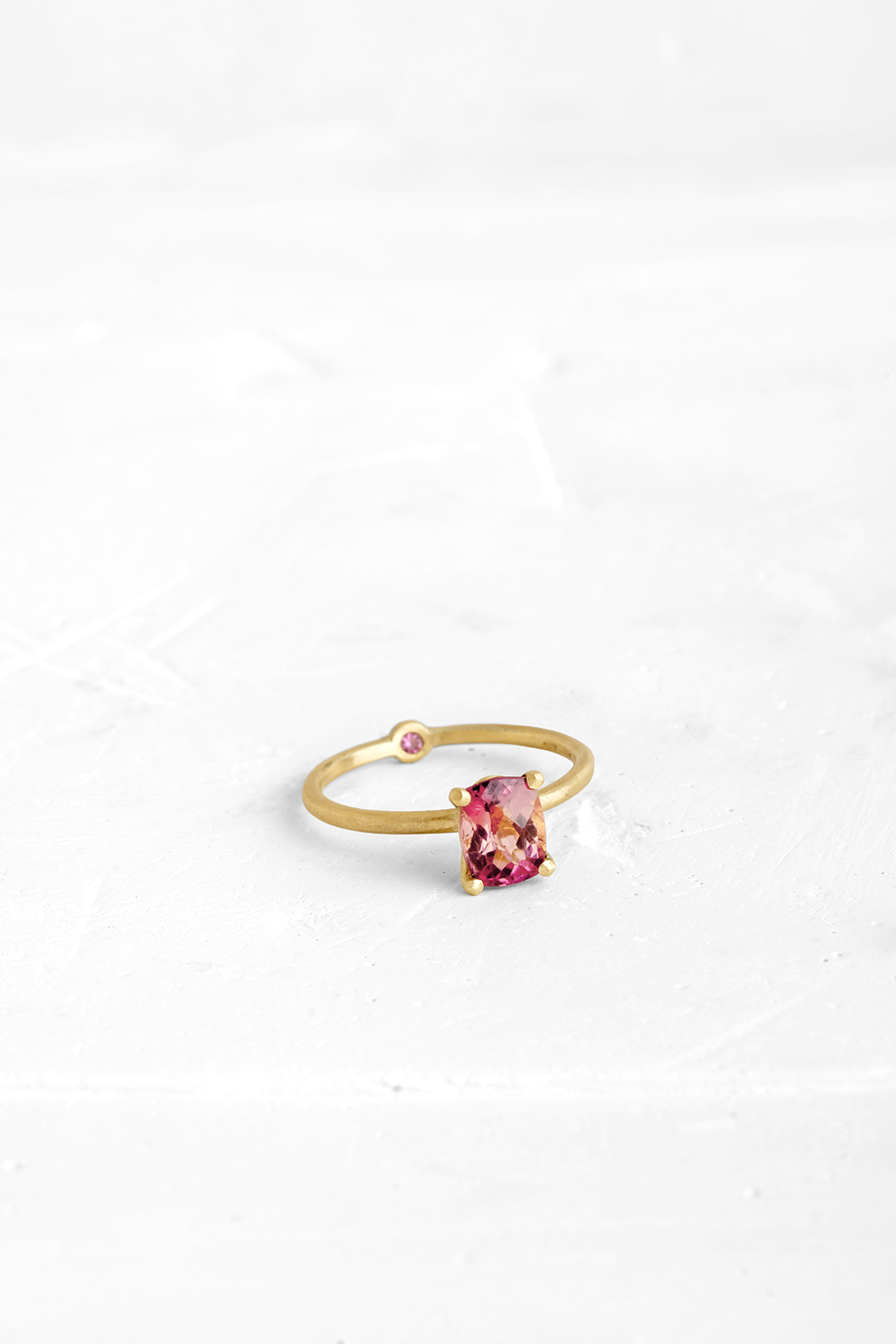 A thin, hoop ring with a setting for a stone or a diamond. The gem shines in its full glory, expo...