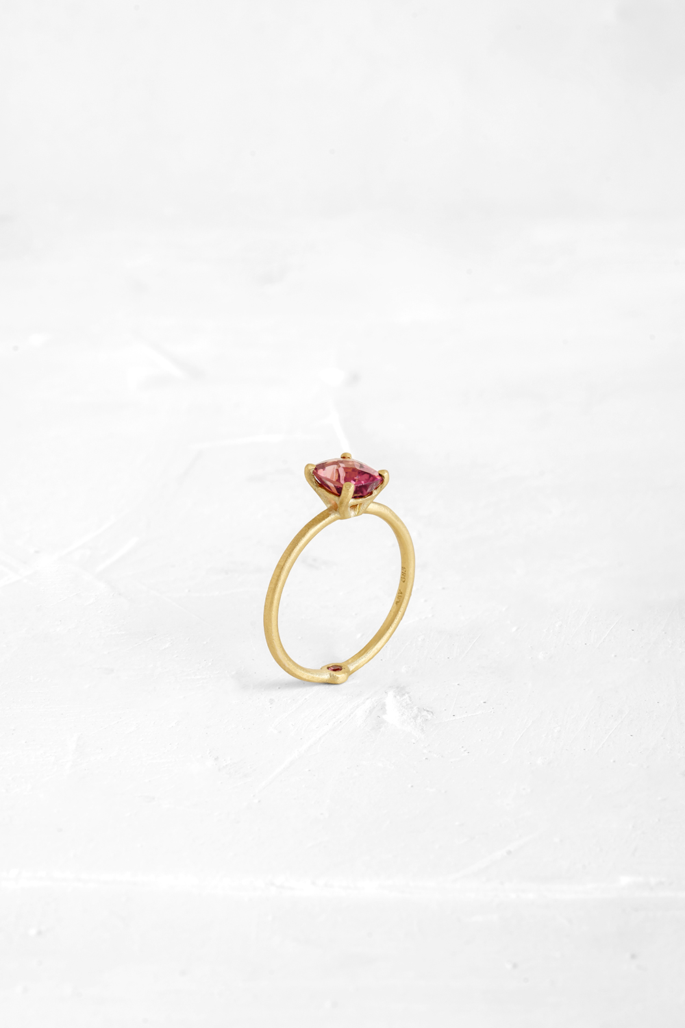 A thin, hoop ring with a setting for a stone or a diamond. The gem shines in its full glory, expo... - View 2