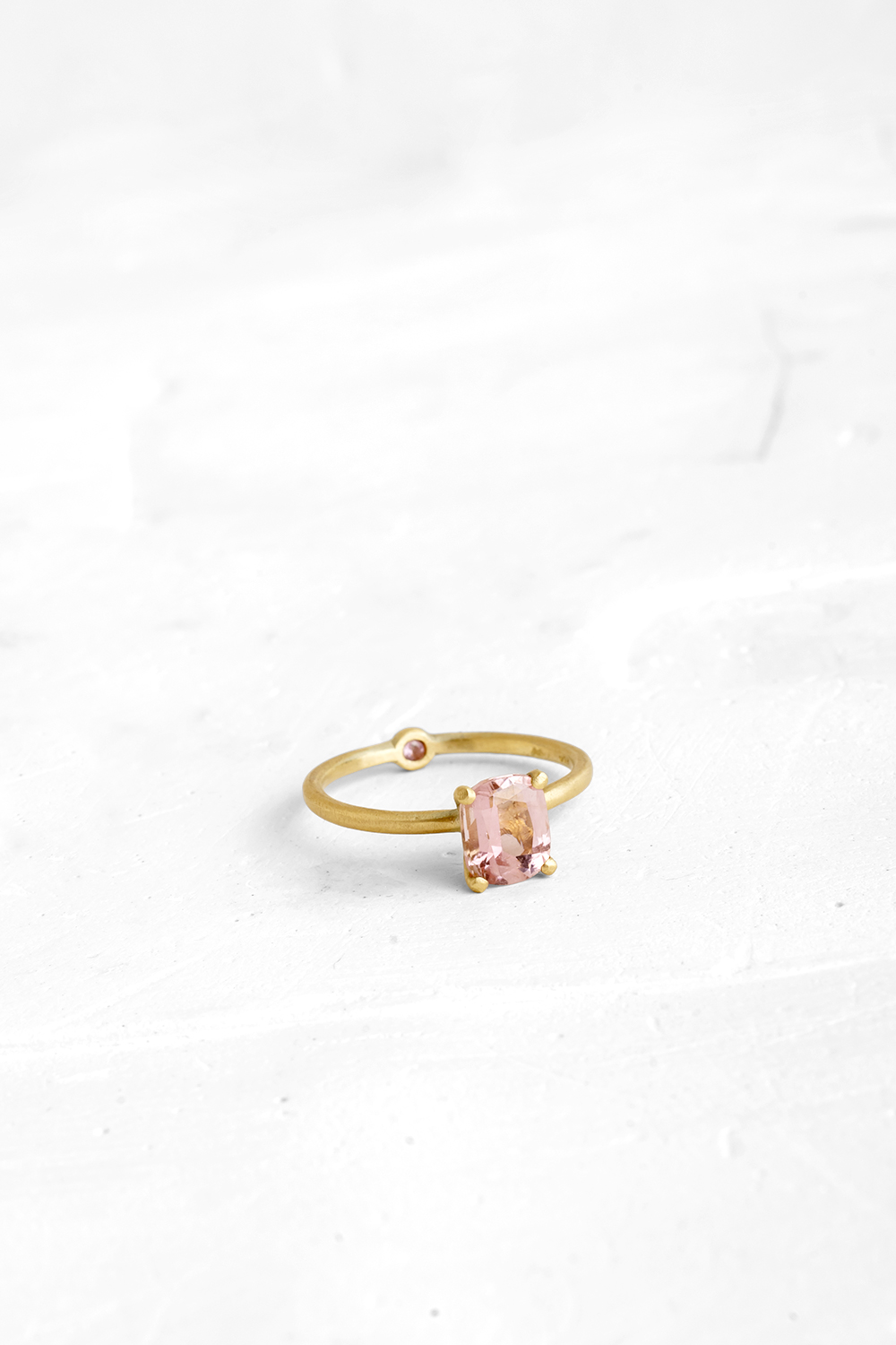 A thin, hoop ring with a setting for a stone or a diamond. The gem shines in its full glory, expo...