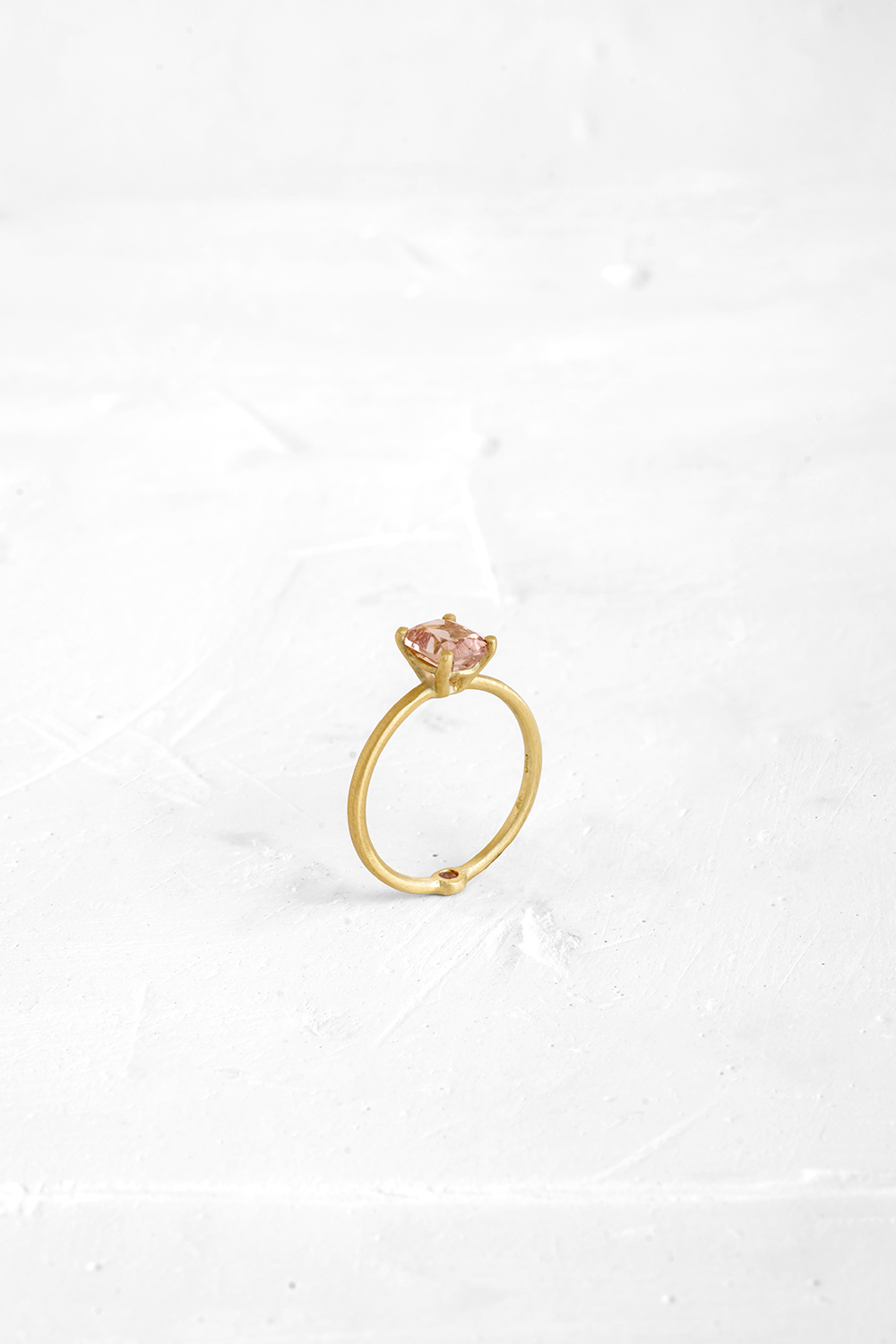 A thin, hoop ring with a setting for a stone or a diamond. The gem shines in its full glory, expo... - View 2