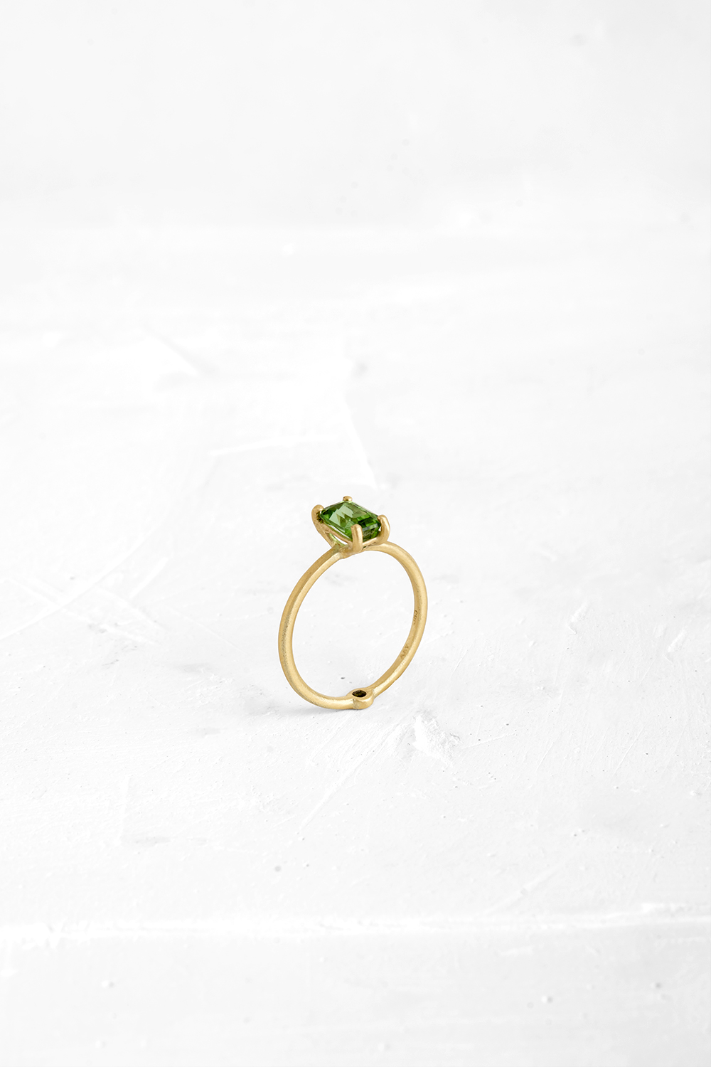 A thin, hoop ring with a setting for a stone or a diamond. The gem shines in its full glory, expo... - View 2