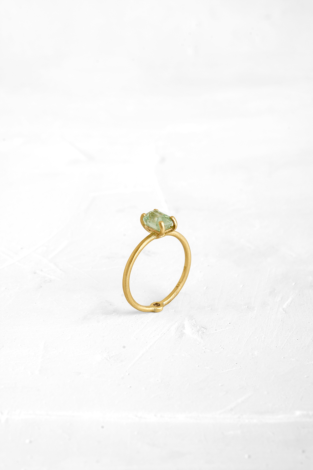 A thin, hoop ring with a setting for a stone or a diamond. The gem shines in its full glory, expo... - View 2