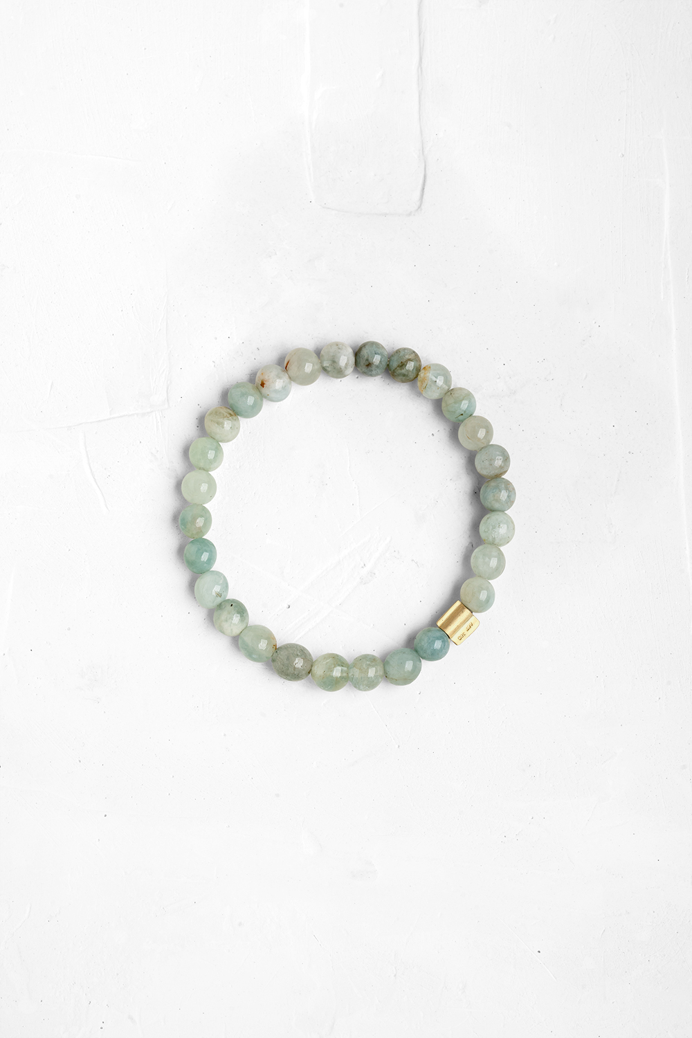 This bracelet is made of a pack of Aqua Marine stones. A gold "wing" shaped bead is also added, a...