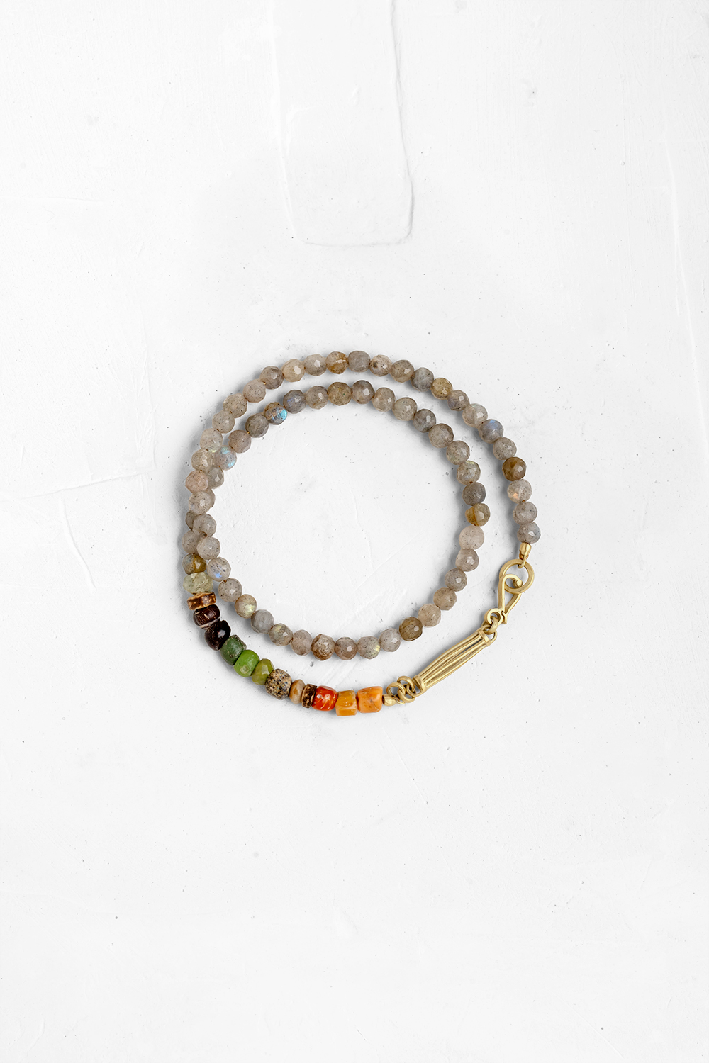 Classic Labradorite bracelet designed with a unique handcrafted gold element & clasp, and a mix o...