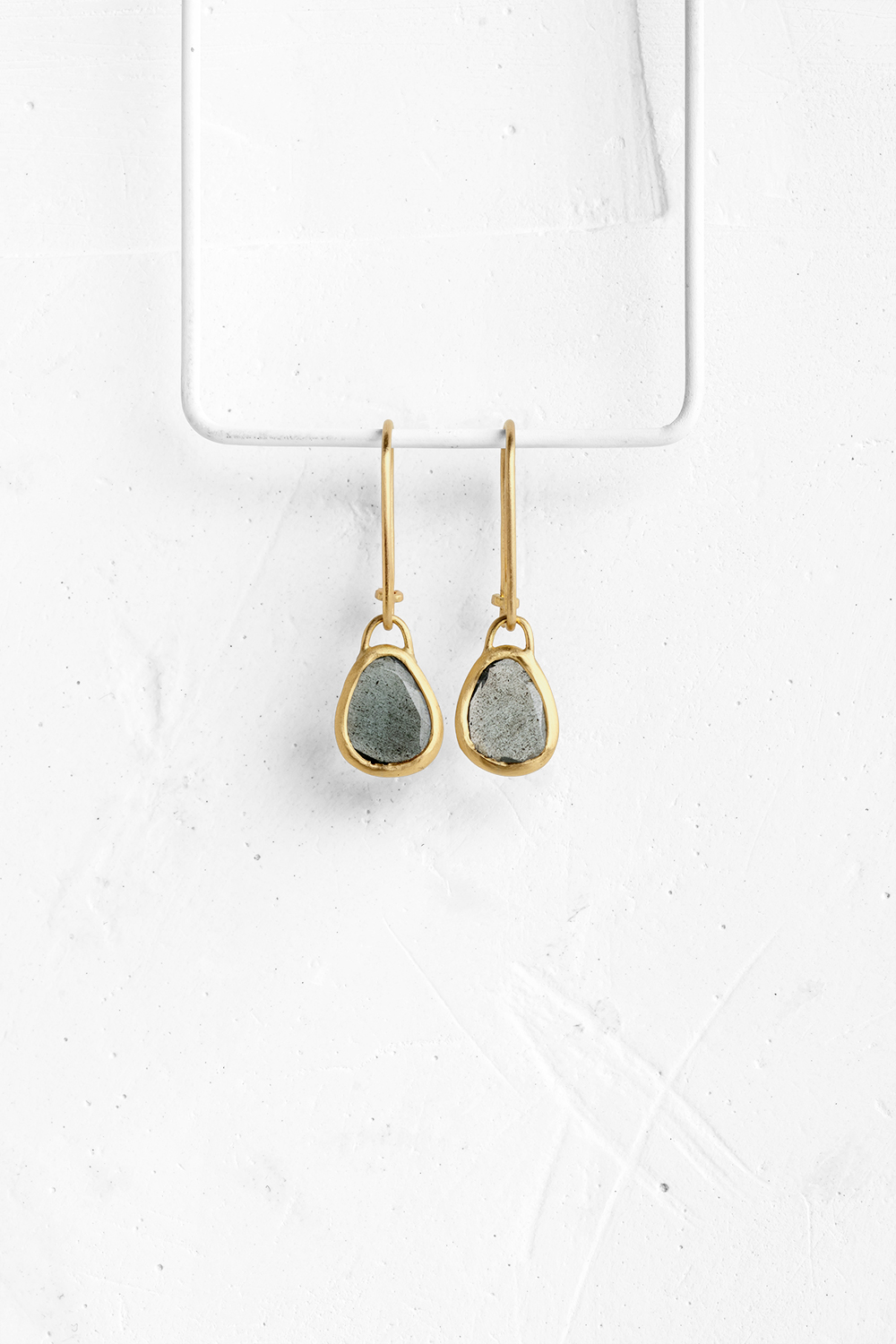 A pair of amorphous Aqua Marine stones with a unik color, wrapped in gold hang from hand crafted ...