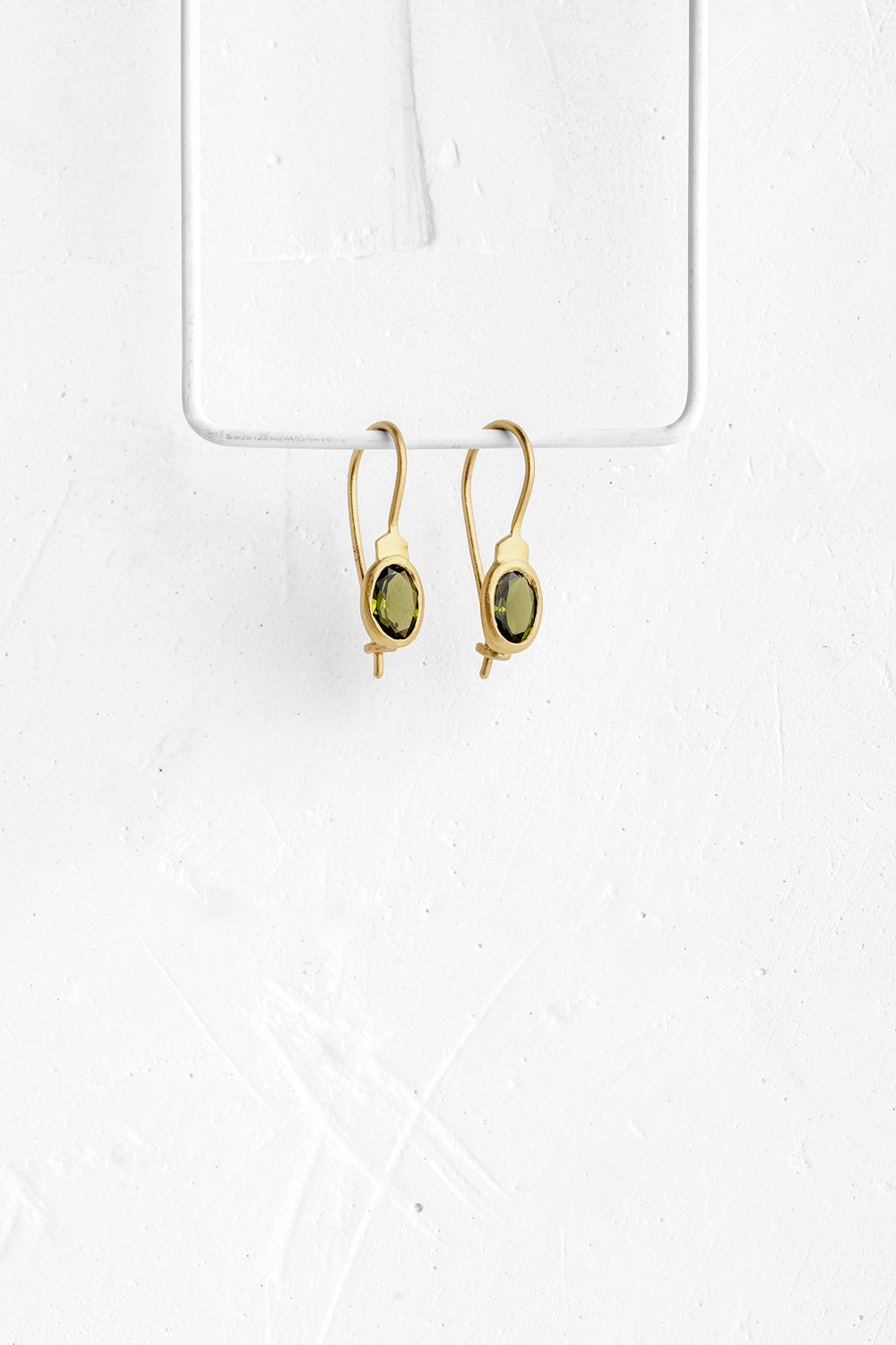 These elegant hanging earrings are set with oval Green Tourmaline stones & wrapped in 18K gold - View 2