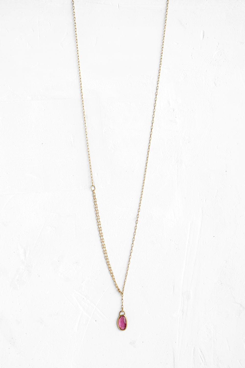 A handmade pendant is set with an oval shape Pink Tourmaline stone which hangs on a delicate chain - View 2