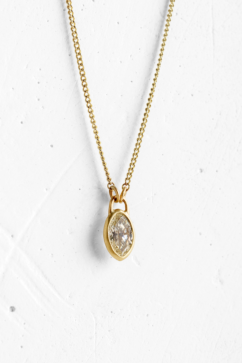 A handmade pendant is set with a Marquise Diamoned - 0.45 CT which hangs on a delicate chain