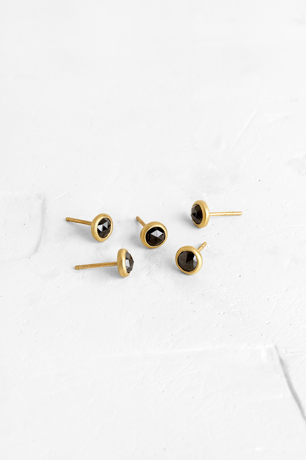 A Black Diamonds stud earrings wrapped in 18K gold
** Each earring is different
** The price is...